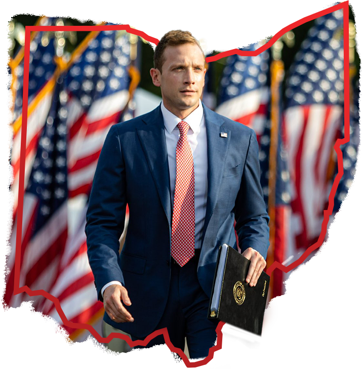 Max Miller walking in front of American flags